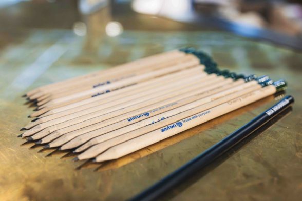 some pencils on a table with amfori logo on it