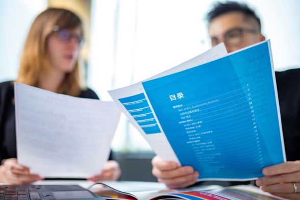 a men and a women looking at documents in Chinese