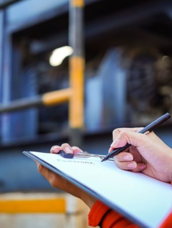 One person taking notes on an audit report